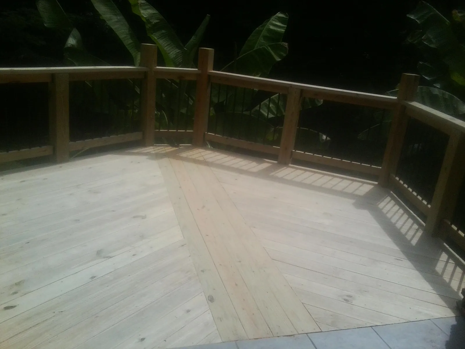 New wood deck and railing built off the back of a home in Bellville